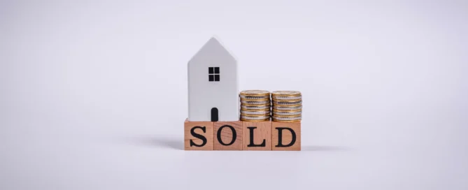 Quick house sale costs - house model with SOLD sign and money